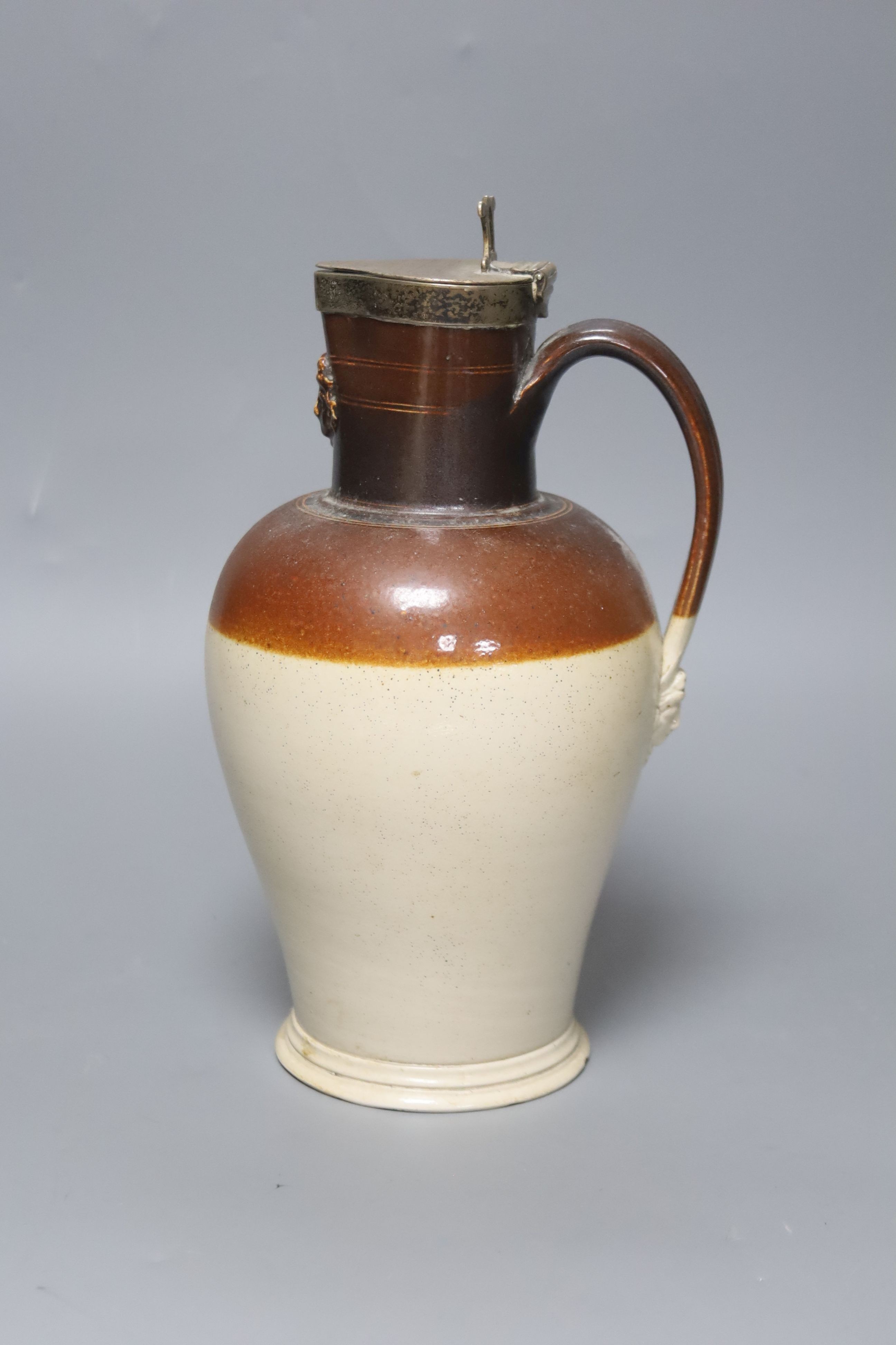 A silver mounted stoneware pitcher ‘presented by Joseph Neeld Esq to Joseph Cirvers 1848’ the base marked ‘Hot water proof’ 26cm